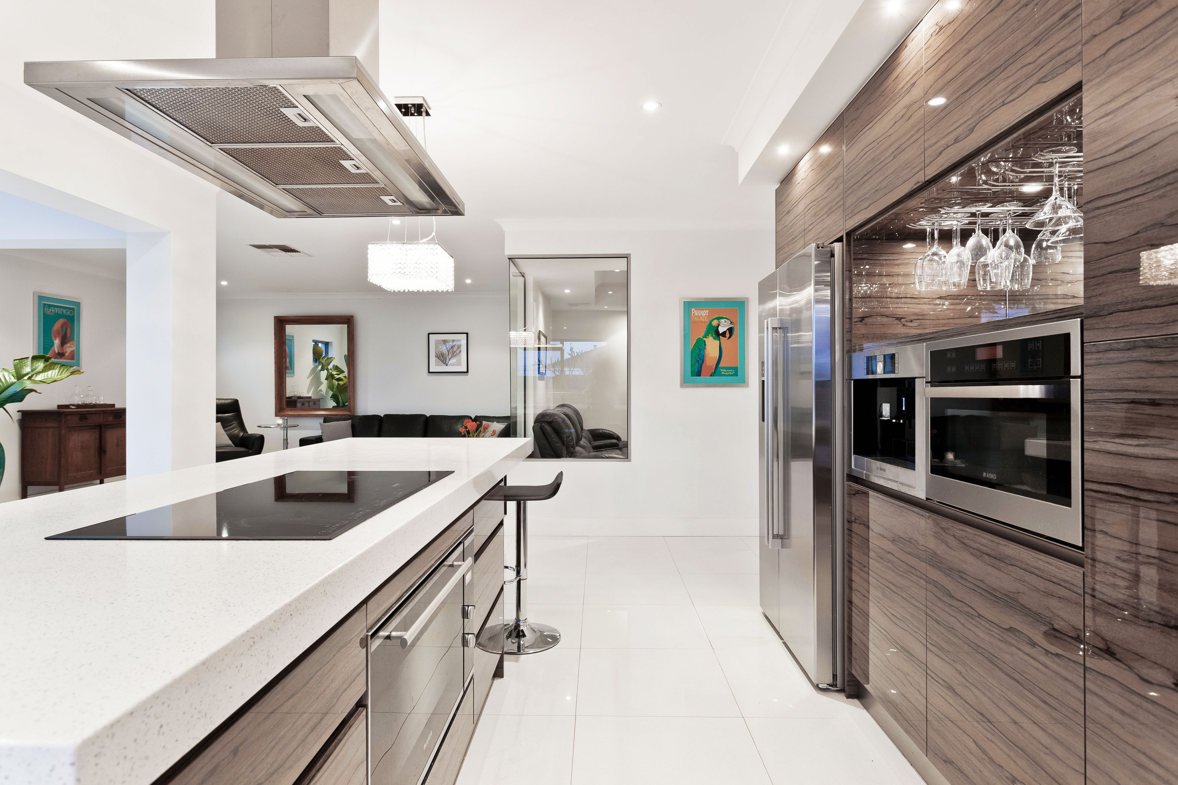 Modern kitchen renovation with wood-grain cabinetry and white stone countertops
