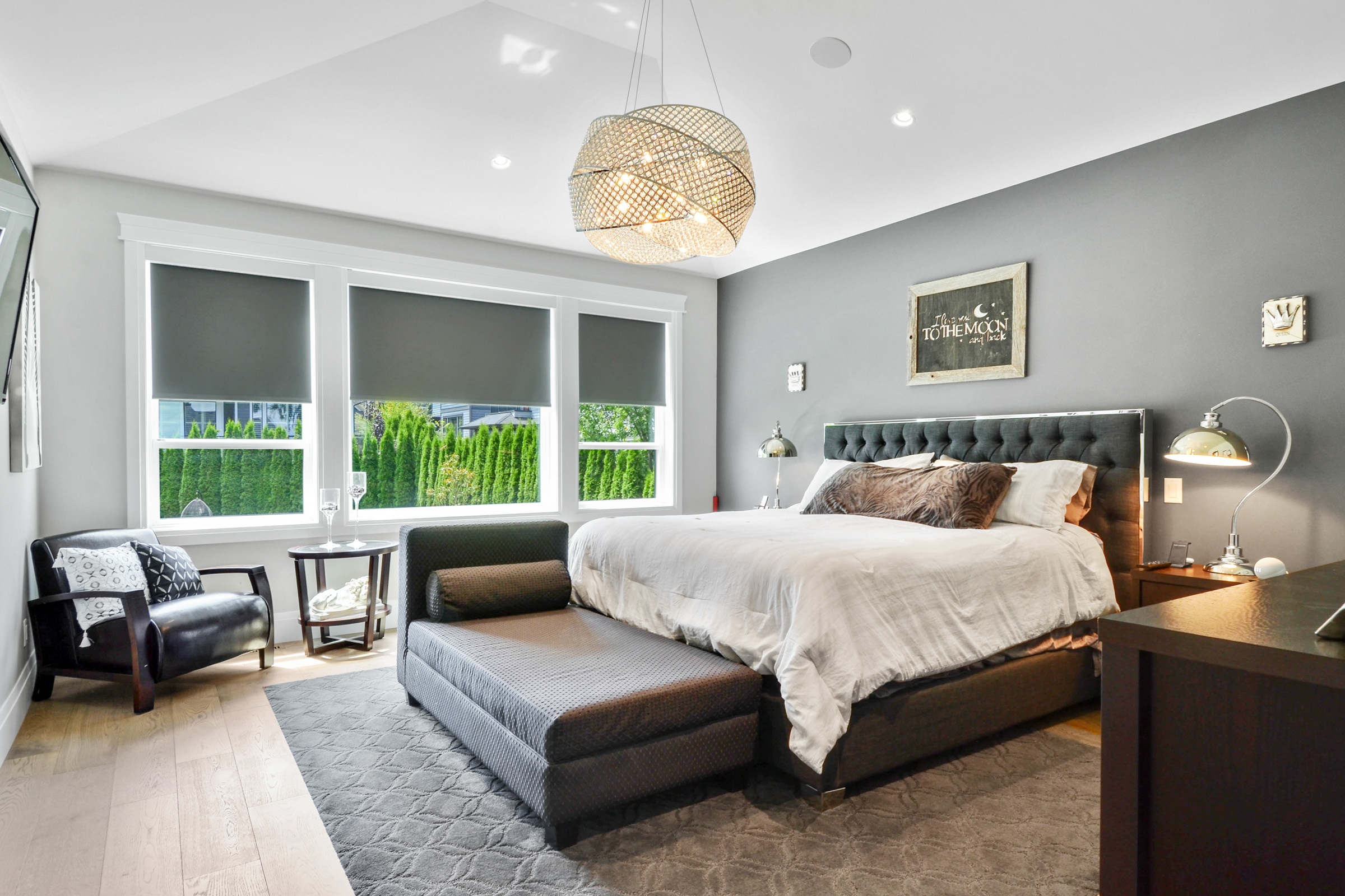 Master bedroom with blackout roller shades on three windows