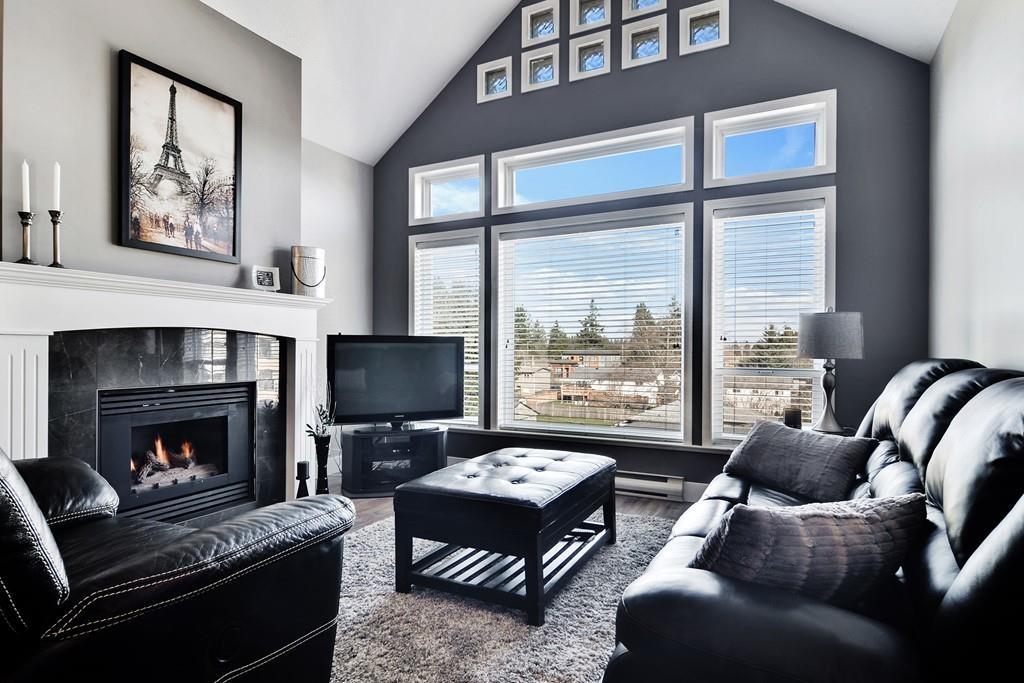 Living room with dark feature wall and gas fireplace