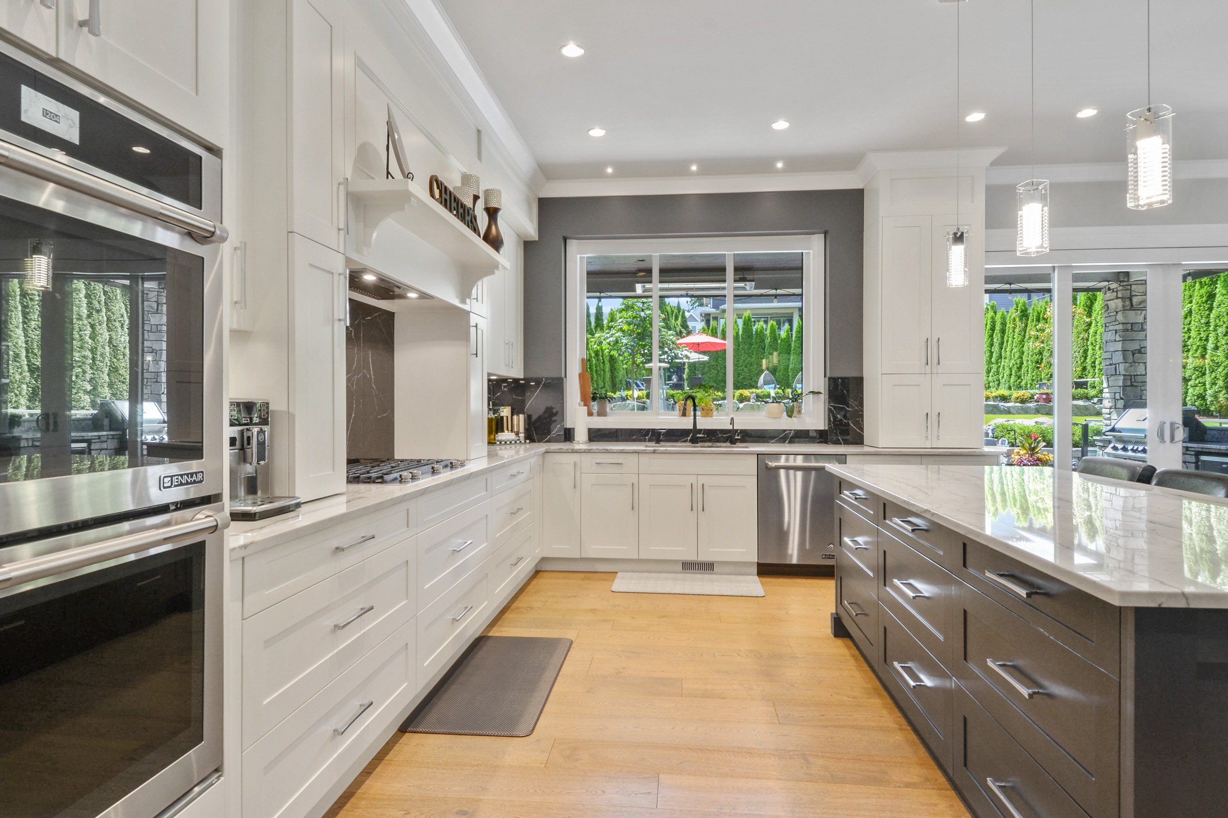 Custom kitchen with white shaker cabinets and dark wood island