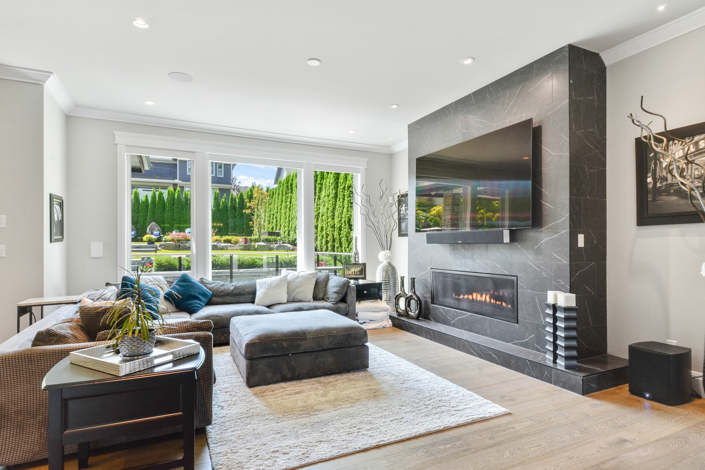 Renovated living room with floor-to-ceiling marble fireplace wall